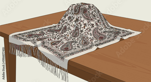 Ornamented cloth with fringe draped over a wooden table