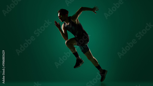 Canvastavla Male athlete performing dynamic sideways jump with extended limbs on dark green background