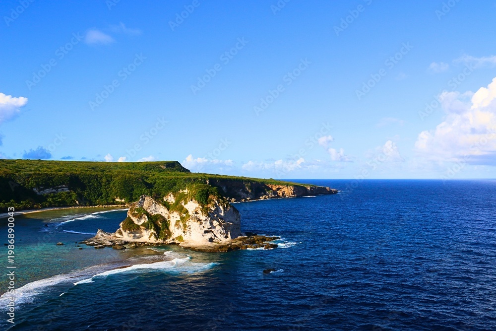 Naklejka premium Paradise Tropical Beach with Blue Sky and White Clouds
