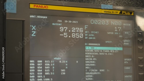 CNC machine control panel display showing machining parameters and absolute coordinates