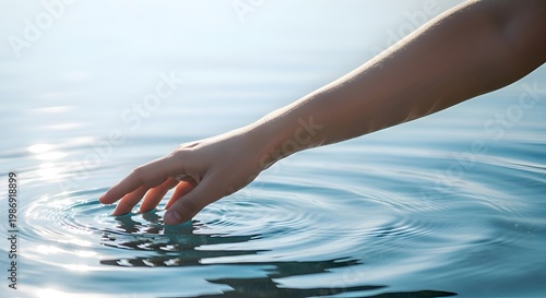 Gentle touch upon the water's surface, a delicate interaction with the aquatic environment, observing the ripple effect and the interplay between human presence and the natural world.