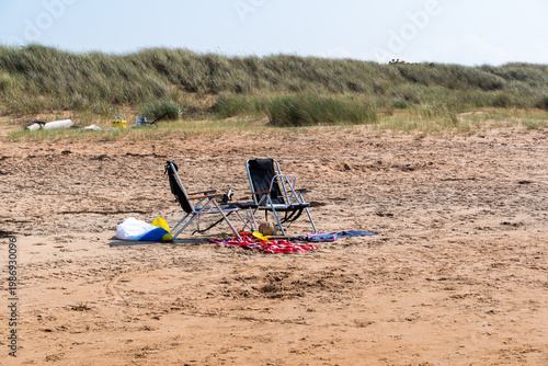Billede på lærred Two unoccupied deckchairs on sandy coastal resort in Southern Sweden