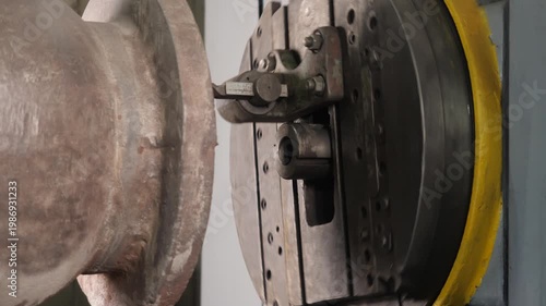 Metal part being machined on a CNC machine with cutting tool in motion
