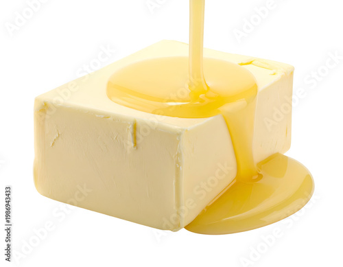 Golden liquid flowing over a creamy yellow block of butter