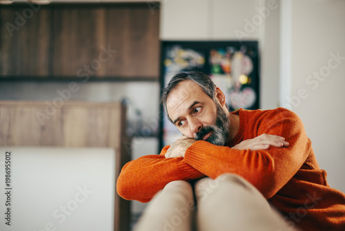 Mature man feeling lonely and pensive at home