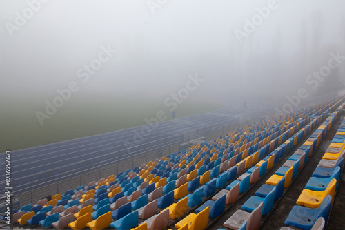 Magical football field in the morning fog