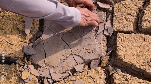 Isolated dry, cracked soil pieces spread on a white background representing drought, climate change, and arid land