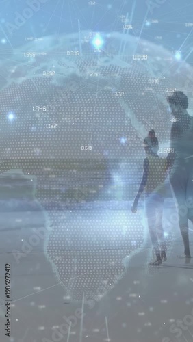 Parent and child exploring shore, child letting go stepping toward water, data globe overlay scene