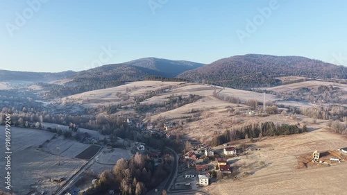 Charming village in Poland with hills and morning mist