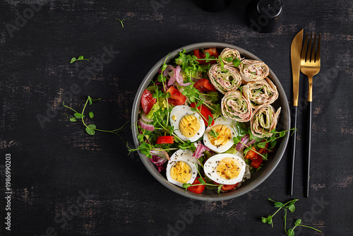 Keto diet meal with tuna lavash rolls salad and boiled eggs. Top view, flat lay