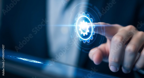 Hand touching digital blue gear on virtual interface