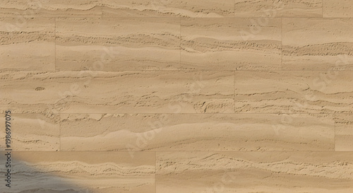 Abstract patterns of textured brown sand form arid dunes under a dry summer sky in this majestic Sahara desert landscape