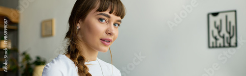 Photos Young woman with beautiful bangs enjoying a cozy moment in her modern apartment