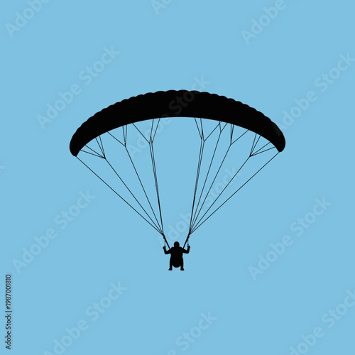 Silhouette Of A Paraglider Soaring Against A Clear Blue Sky