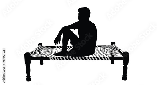 Man sitting on a traditional charpoy bed in a relaxed pose