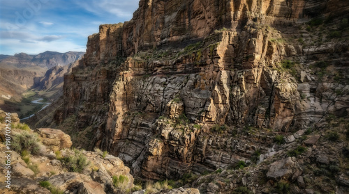 Rugged Sedimentary Cliff Face with Layered Rock Formations and Erosion Patterns