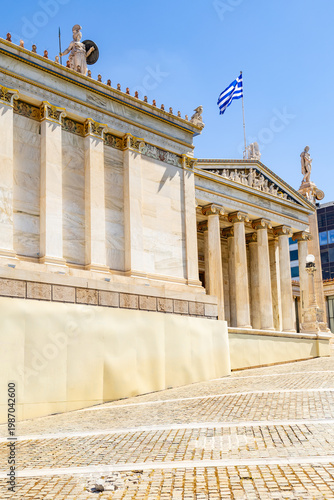 The neoclassical building of the modern Academy of Athens. Statues of Athena and Apollo stand atop the columns. Athens, Panepistimio, Greece
