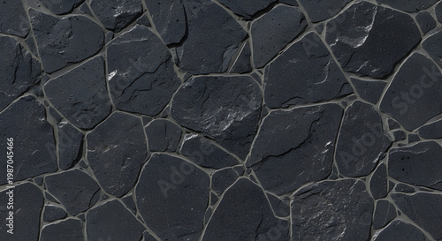 Rough grey stone wall texture featuring an old rock pattern and weathered construction material for a textured building surface or paving structure
