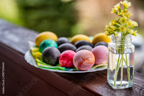 Wallpaper Mural Dyed easter egg in plate, small vase with primrose on wooden railing. Torontodigital.ca