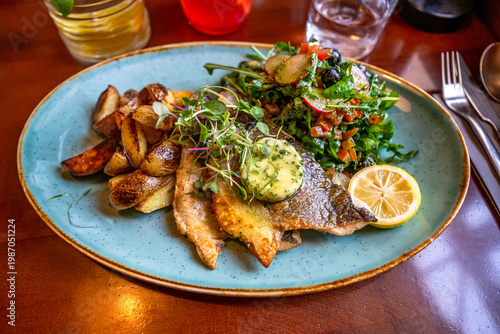 Wallpaper Mural Roasted cod fish fillet with vegetable salad, baked potato and herb butter on blue plate Torontodigital.ca