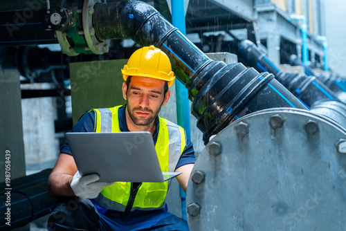 Quadro em tela Industrial worker using laptop inspecting pipeline system in factory environment