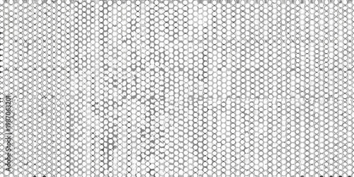 Intricate patterned mesh of small circular openings in grayscale