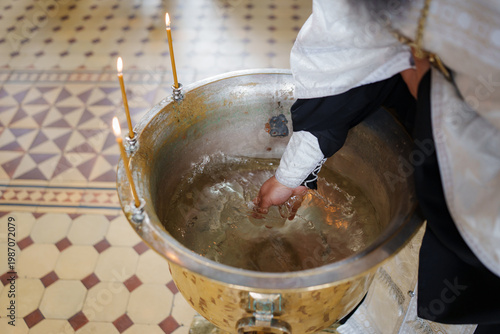 Person performing baptism at a church with holy water