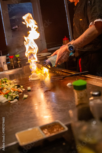 Photography Hibachi chef faming up the vegetables