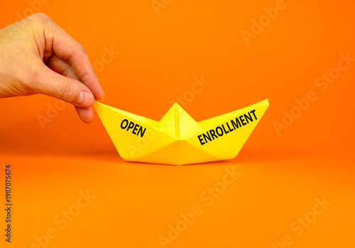 Open enrollment words symbol. Concept words Open enrollment on beautiful yellow paper boat. Beautiful orange background. Doctor hand. Medical and Open enrollment words concept. Copy space.