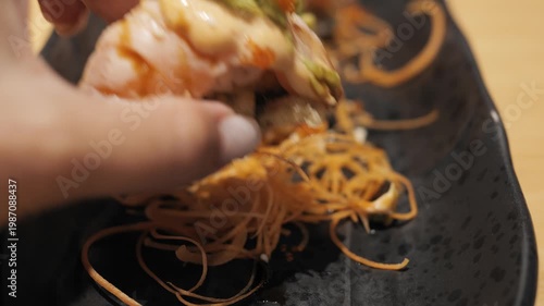 Gastronomic experience roll in hand roll texture detail roll with salmon avocado caviar millennial hand interaction with food taste exploration closeup shot asian cuisine concept delicious moment