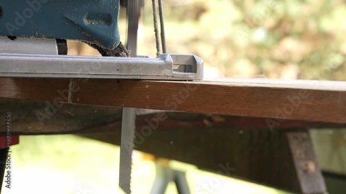 Professional carpenter using power tool in woodworking industry tool operation in workshop tool for cutting wood and construction materials carpenter work with tool in carpentry production process