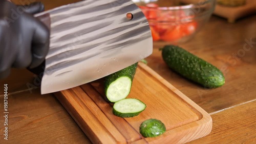 Professional kitchen chef hands using knife knife precision cutting technique knife skill detail fresh cucumber slicing culinary preparation cooking process macro shot food preparation concept