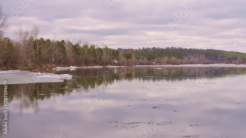 Natural calm quiet river scene with soft reflection and cloudy sky reflection on water surface reflection creates peaceful mood tranquil landscape gentle flow atmospheric nature view serenity concept