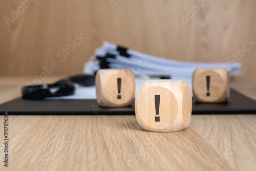 Multiple exclamation marks on wooden blocks. Corporate risk concept.