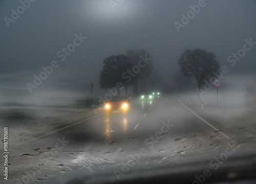 Cars in icy and foggy winter with poor visibility. Speed limit 80 km/h. 