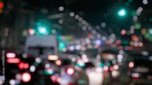 Vehicles travel through a lit road, lights blending into bokeh.