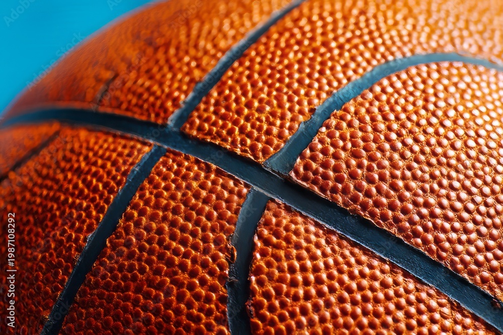 Fototapeta premium close-up of a basketball texture isolated on a light blue background, basketball ball on blue background, close up of a basketball