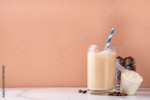 фотографія Iced protein coffee, whey isolate latte drink with whey protein powder in scoop