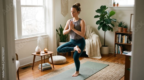 A young woman practices yoga in a cozy, sunlit room, balancing in tree pose on a mat, surrounded by plants, calm decor, and a peaceful, mindful atmosphere.