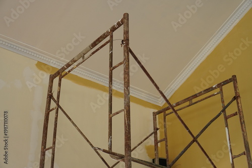 Rusty metal scaffolding frame inside a room during home renovation