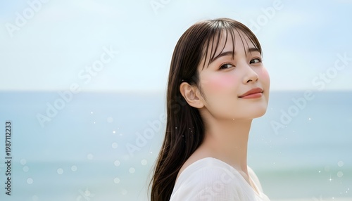 海をバックに透明感と清潔感のある若い女性のビューティーポートレート