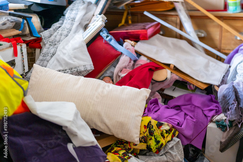 cluttered room with piles clothes and objects, chaotic interior, hoarding disorder concept, mess and overload, domestic space hoarding behavior and accumulation, lack organization mental overload