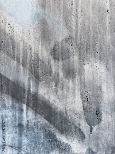 Abstract background showing grey and blue paint dripping and streaking on metal