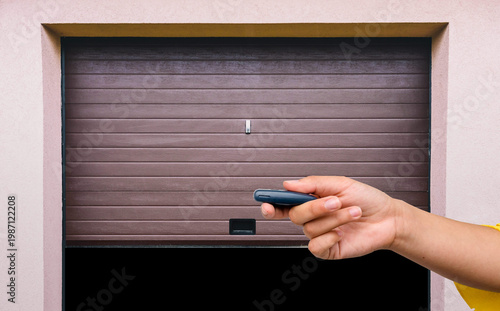 Garage door PVC. Hand use remote controller for closing and opening garage door

