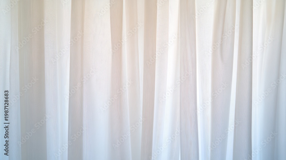 Obraz premium Vertical folds of translucent white curtains illuminated by bright light from behind