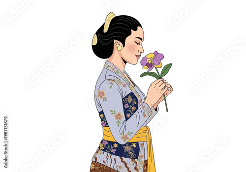 Woman in traditional dress smelling a purple flower closely