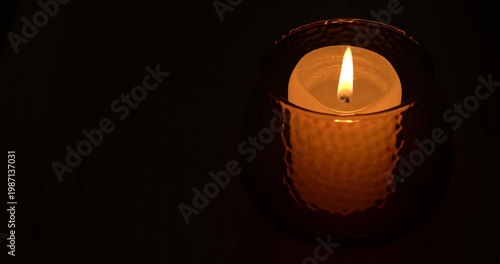Candle is lit, burns and blows out on a black background.