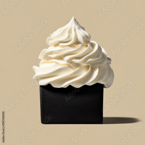 Elegant Black Cube Soap with Swirled White Cream Topping on Beige.