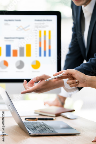 Konstfotografi Professional business partners analyzing complex financial dashboard and colorful charts on laptop in a modern office