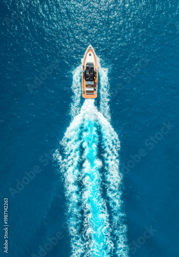 Fotografie Aerial drone view of speed boat in crystal clear turquoise water